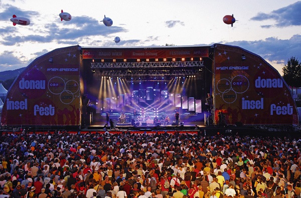 Image of musicians having fun and performing infront of the large crowd in a musical evening.