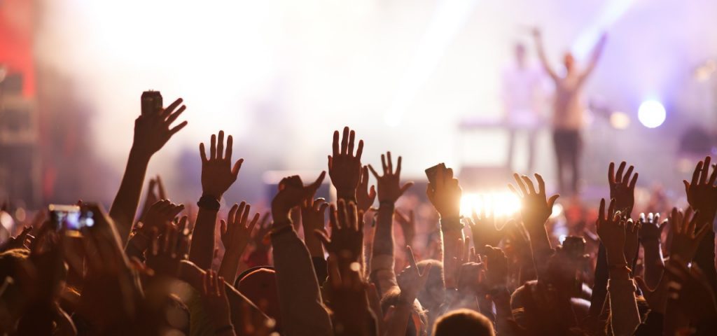 Image of a crowd surfing in the musical concert.