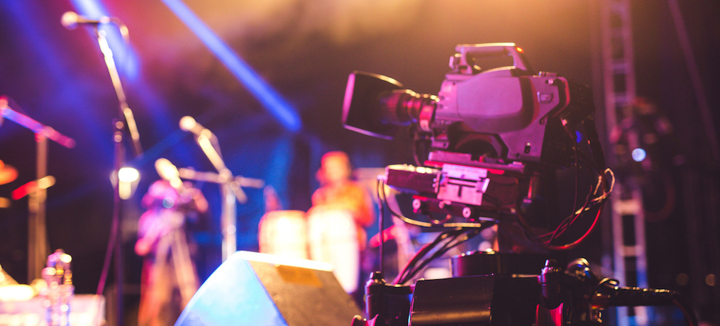 A Selective focus of Video Camera in a blur backstage background.